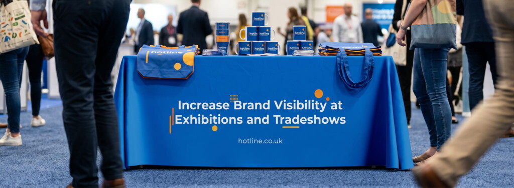 Branded tablecloth with promotional merchandise at a trade show event