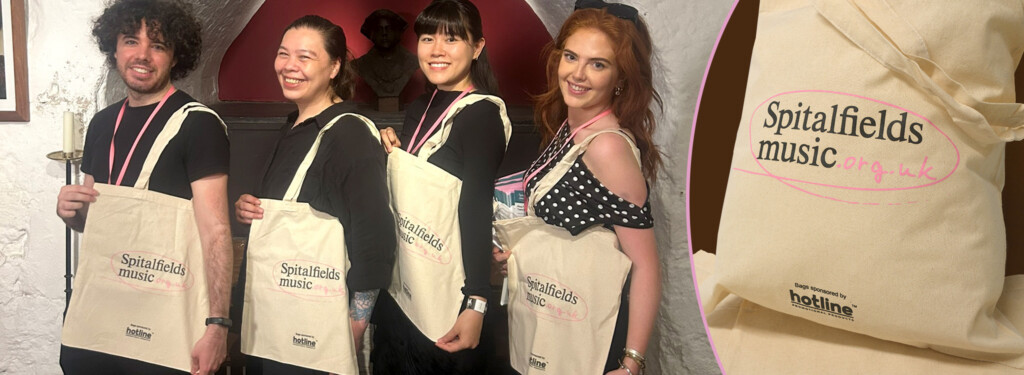 Members of the Spitalfields Music front of house team with branded cotton tote bags.