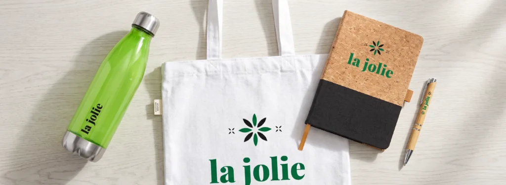 Sustainable promotional merchandise including reusable bottle, recycled notebook, bamboo pen and cotton tote bag